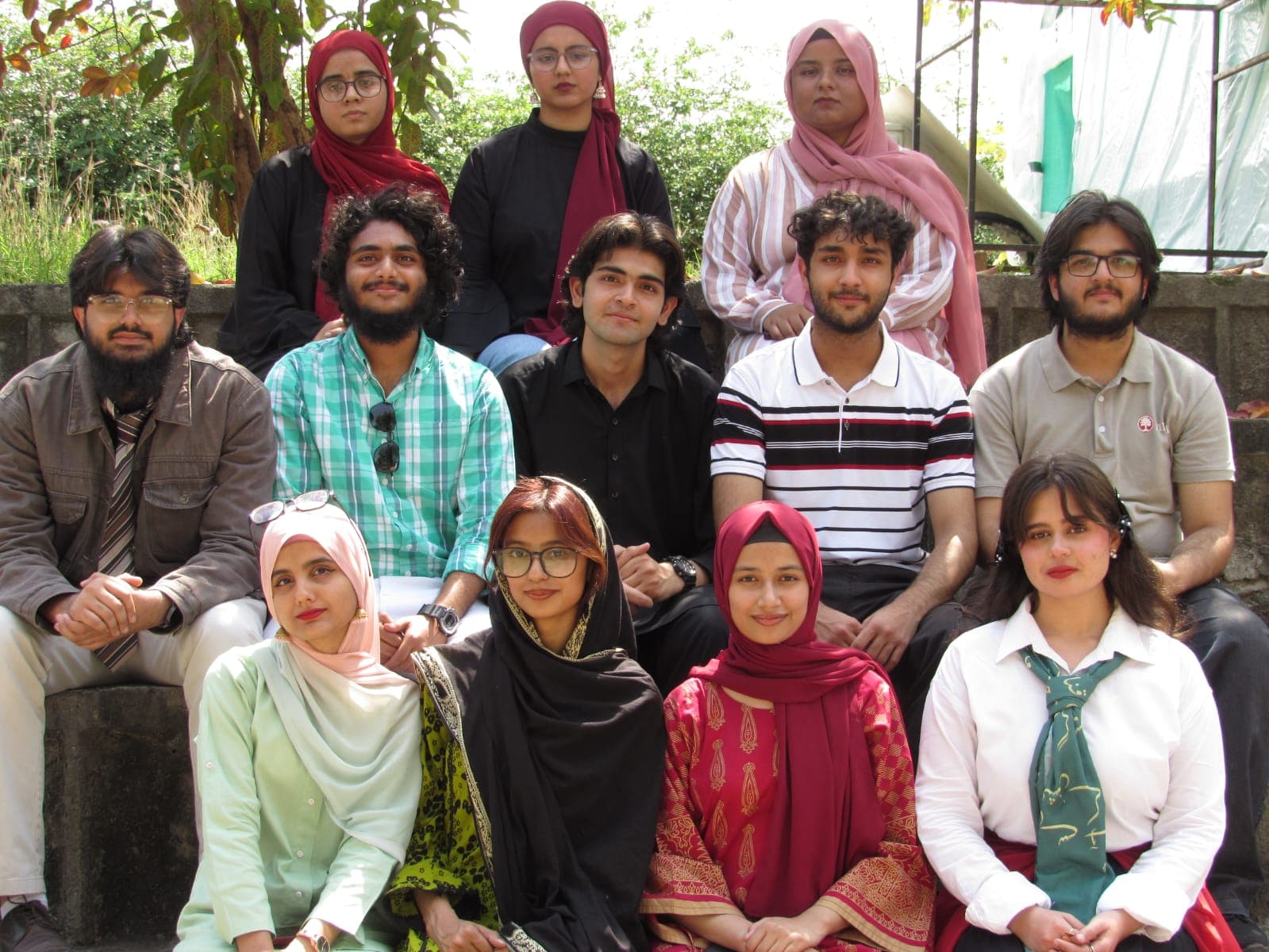 A larger group portrait of the NMN team on outdoor steps.